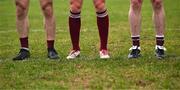 23 February 2025; The socks and boots of Galway footballers, from left, Liam Silke, Shane Walsh and Céin Darcy as they stand for the national anthem before the Allianz Football League Division 1 match between Galway and Donegal at Pearse Stadium in Galway. Photo by Piaras Ó Mídheach/Sportsfile