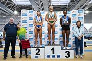 22 February 2025; Athletics Ireland President John Cronin, far left, and Athletics Coach Noelle Morrissey, far right, with women's 60m hurdles medallists, Sarah Lavin of Emerald AC, Limerick, gold, centre, Molly Scott of St Laurence O'Toole AC, Carlow, silver, left, and Arabella Adekoya of St Laurence O'Toole AC, Carlow, bronze, right,during day one of the 123.ie National Senior Indoor Championships at the National Indoor Arena on the Sport Ireland Campus in Dublin. Photo by Sam Barnes/Sportsfile
