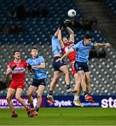 22 February 2025; Conor Glass of Derry in action against Brian Howard and David Byrne, right, of Dublin during the Allianz Football League Division 1 match between Dublin and Derry at Croke Park in Dublin. Photo by Piaras Ó Mídheach/Sportsfile