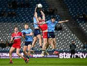 22 February 2025; Conor Glass of Derry in action against Brian Howard and David Byrne, right, of Dublin during the Allianz Football League Division 1 match between Dublin and Derry at Croke Park in Dublin. Photo by Piaras Ó Mídheach/Sportsfile
