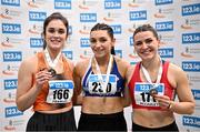 23 February 2025; Women's long jump medallists, Lauren Callaghan of Finn Valley AC, Donegal, gold, centre, Laura Frawley of Nenagh Olympic AC, Tipperary, silver, left, and Anna McCauley of City of Lisburn AC, Down, right, bronze, during day two of the 123.ie National Senior Indoor Championships at the National Indoor Arena on the Sport Ireland Campus in Dublin. Photo by Sam Barnes/Sportsfile