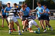 27 February 2025; Sam Dunne of St Michael's College is tackled by Belvedere College players, from left, Daniel Sweeney, Adam Keeling and Conor Stafford during the Bank of Ireland Leinster Rugby Boys Schools Junior Cup second round match between St Michael's College and Belvedere College at Energia Park in Dublin. Photo by Shauna Clinton/Sportsfile