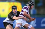 27 February 2025; Lucas Aveling of Clongowes Wood College is tackled by Donal Larkin of Newbridge College during the Bank of Ireland Leinster Rugby Boys Schools Junior Cup second round match between Clongowes Wood College and Newbridge College at Energia Park in Dublin. Photo by Shauna Clinton/Sportsfile