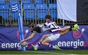 27 February 2025; Donal Larkin of Newbridge College scores his side's second try despite the efforts of Michael McCormick of Clongowes Wood College during the Bank of Ireland Leinster Rugby Boys Schools Junior Cup second round match between Clongowes Wood College and Newbridge College at Energia Park in Dublin. Photo by Shauna Clinton/Sportsfile