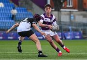 27 February 2025; Tom English of Clongowes Wood College in action against Seán Lynch of Newbridge College during the Bank of Ireland Leinster Rugby Boys Schools Junior Cup second round match between Clongowes Wood College and Newbridge College at Energia Park in Dublin. Photo by Shauna Clinton/Sportsfile