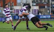 27 February 2025; Lucas Aveling of Clongowes Wood College is tackled by Saul Brewster of Newbridge College during the Bank of Ireland Leinster Rugby Boys Schools Junior Cup second round match between Clongowes Wood College and Newbridge College at Energia Park in Dublin. Photo by Shauna Clinton/Sportsfile