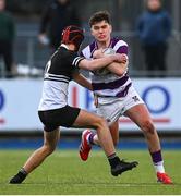 27 February 2025; Tom English of Clongowes Wood College is tackled by Lucas Flynn of Newbridge College during the Bank of Ireland Leinster Rugby Boys Schools Junior Cup second round match between Clongowes Wood College and Newbridge College at Energia Park in Dublin. Photo by Shauna Clinton/Sportsfile