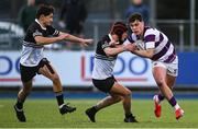 27 February 2025; Tom English of Clongowes Wood College is tackled by Lucas Flynn of Newbridge College during the Bank of Ireland Leinster Rugby Boys Schools Junior Cup second round match between Clongowes Wood College and Newbridge College at Energia Park in Dublin. Photo by Shauna Clinton/Sportsfile