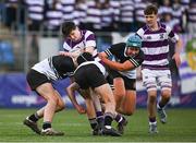 27 February 2025; Scott Morrissey of Clongowes Wood College is tackled by Newbridge College players, from left, Josh D'Alton, Paddy White and Jack Scott during the Bank of Ireland Leinster Rugby Boys Schools Junior Cup second round match between Clongowes Wood College and Newbridge College at Energia Park in Dublin. Photo by Shauna Clinton/Sportsfile
