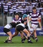 27 February 2025; Scott Morrissey of Clongowes Wood College is tackled by Newbridge College players, from left, Josh D'Alton, Paddy White and Jack Scott during the Bank of Ireland Leinster Rugby Boys Schools Junior Cup second round match between Clongowes Wood College and Newbridge College at Energia Park in Dublin. Photo by Shauna Clinton/Sportsfile