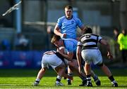 27 February 2025; Joshua Neville of St Michael's College is tackled by Belvedere College players Elliot Scanlan, left, and Jack Moyles during the Bank of Ireland Leinster Rugby Boys Schools Junior Cup second round match between St Michael's College and Belvedere College at Energia Park in Dublin. Photo by Shauna Clinton/Sportsfile