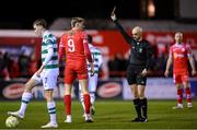 28 February 2025; Sean Boyd of Shelbourne is shown a yellow card by referee Neil Doyle during the SSE Airtricity Men's Premier Division match between Shelbourne and Shamrock Rovers at Tolka Park in Dublin. Photo by Stephen McCarthy/Sportsfile