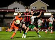 28 February 2025; Bohemians goalkeeper James Talbot collects the ball ahead of teammate Sean Grehan under pressure from Charlie Lyons of Cork City during the SSE Airtricity Men's Premier Division match between Cork City and Bohemians at Turner's Cross in Cork. Photo by Michael P Ryan/Sportsfile