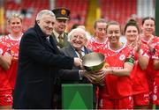 1 March 2025; Shelbourne captian Pearl Slattery is presented with the FAI President's Cup by President of Ireland Michael D Higgins and FAI President Paul Cooke, left, after the 2025 Women's President's Cup match between Shelbourne and Athlone Town at Tolka Park in Dublin. Photo by Stephen McCarthy/Sportsfile