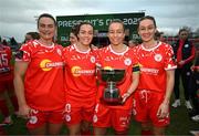 1 March 2025; Shelbourne players, from left, Jemma Quinn, Noelle Murray, Pearl Slattery and Rachel Graham celebrate with the FAI President's Cup after the 2025 Women's President's Cup match between Shelbourne and Athlone Town at Tolka Park in Dublin. Photo by Stephen McCarthy/Sportsfile
