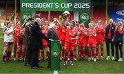1 March 2025; Shelbourne captian Pearl Slattery is presented with the FAI President's Cup by President of Ireland Michael D Higgins and FAI President Paul Cooke, left, after the 2025 Women's President's Cup match between Shelbourne and Athlone Town at Tolka Park in Dublin. Photo by Stephen McCarthy/Sportsfile
