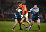1 March 2025; Jason Duffy of Armagh is tackled by Greg McEneany, left, and Brian Howard of Dublin during the Allianz Football League Division 1 match between Armagh and Dublin at the BOX-IT Athletic Grounds in Armagh. Photo by Ben McShane/Sportsfile