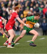 2 March 2025; Hugh McFadden of Donegal in action against Conor Glass of Derry during the Allianz Football League Division 1 match between Donegal and Derry at Fr Tierney Park in Ballyshannon, Donegal. Photo by Ramsey Cardy/Sportsfile