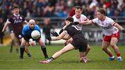 2 March 2025; Robert Finnerty of Galway makes a pass under pressure from Tyrone players Kieran McGeary and Mark Bradley, right, as referee Brendan Cawley looks on during the Allianz Football League Division 1 match between Galway and Tyrone at Tuam Stadium in Tuam, Galway. Photo by Piaras Ó Mídheach/Sportsfile