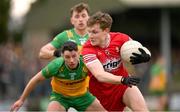 2 March 2025; Ethan Doherty of Derry in action against Ryan McHugh of Donegal during the Allianz Football League Division 1 match between Donegal and Derry at Fr Tierney Park in Ballyshannon, Donegal. Photo by Ramsey Cardy/Sportsfile