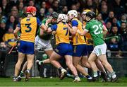 2 March 2025; Diarmaid Byrnes of Limerick, second from left, tussles with Clare players Darragh Lohan and Adam Hogan of Clare after an incident for which he was shown a red card during the Allianz Hurling League Division 1A match between Limerick and Clare at TUS Gaelic Grounds in Limerick. Photo by Brendan Moran/Sportsfile