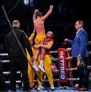 1 March 2025; Paddy Donovan, is lifted by trainer Andy Lee, after his IBF welterweight eliminator bout against Lewis Crocker at SSE Arena in Belfast. Photo by Ramsey Cardy/Sportsfile