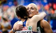7 March 2025; Sarah Lavin of Ireland, right, and Reetta Hurske of Finland embrace after the women's 60m hurdles final during day two of the European Athletics Indoor Championships 2025 at the Omnisport Apeldoorn in Apeldoorn, Netherlands. Photo by Sam Barnes/Sportsfile