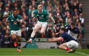 8 March 2025; Jamie Osborne of Ireland evades the tackle of Pierre-Louis Barassi of France during the Guinness Six Nations Rugby Championship match between Ireland and France at the Aviva Stadium in Dublin. Photo by Seb Daly/Sportsfile