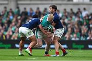 8 March 2025; Jamie Osborne of Ireland is tackled by Yoram Moefana, left, and Damian Penaud of France during the Guinness Six Nations Rugby Championship match between Ireland and France at the Aviva Stadium in Dublin. Photo by Brendan Moran/Sportsfile