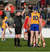 9 March 2025; Referee Liam Gordon shows a red card to David Fitzgerald of Clare during the Allianz Hurling League Division 1A match between Clare and Cork at Zimmer Biomet Páirc Chíosóg in Ennis, Clare.  Photo by John Sheridan/Sportsfile
