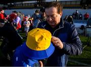 9 March 2025; Marty Morrisey signs a young Clare supporters hat after the Allianz Hurling League Division 1A match between Clare and Cork at Zimmer Biomet Páirc Chíosóg in Ennis, Clare.  Photo by John Sheridan/Sportsfile