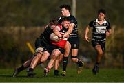 9 March 2025; Shane Farrar of Wicklow is tackled by Kilkenny players Garry Dunne, left, and Geoff Power of Kilkenny during the Bank of Ireland Provincial Towns Cup Round 2 match between Kilkenny RFC and Wicklow RFC at Foulkstown in Kilkenny. Photo by Seb Daly/Sportsfile