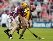 12 September 2004; Nicholas Kenny, Kilkenny, in action against Martin Ryan, Galway. All-Ireland Minor Hurling Championship Final, Galway v Kilkenny, Croke Park, Dublin. Picture credit; Brian Lawless / SPORTSFILE *** Local Caption *** Any photograph taken by SPORTSFILE during, or in connection with, the 2004 Guinness All-Ireland Hurling Final which displays GAA logos or contains an image or part of an image of any GAA intellectual property, or, which contains images of a GAA player/players in their playing uniforms, may only be used for editorial and non-advertising purposes.  Use of photographs for advertising, as posters or for purchase separately is strictly prohibited unless prior written approval has been obtained from the Gaelic Athletic Association.