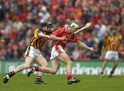 12 September 2004; Niall McCarthy, Cork, in action against Peter Barry, Kilkenny. Guinness All-Ireland Senior Hurling Championship Final, Cork v Kilkenny, Croke Park, Dublin. Picture credit; Brendan Moran / SPORTSFILE *** Local Caption *** Any photograph taken by SPORTSFILE during, or in connection with, the 2004 Guinness All-Ireland Hurling Final which displays GAA logos or contains an image or part of an image of any GAA intellectual property, or, which contains images of a GAA player/players in their playing uniforms, may only be used for editorial and non-advertising purposes.  Use of photographs for advertising, as posters or for purchase separately is strictly prohibited unless prior written approval has been obtained from the Gaelic Athletic Association.