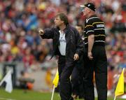 12 September 2004; Cork manager Donal O'Grady, left, and Kilkenny manager Brian Cody issue instructions to their respective teams. Guinness All-Ireland Senior Hurling Championship Final, Cork v Kilkenny, Croke Park, Dublin. Picture credit; Brendan Moran / SPORTSFILE *** Local Caption *** Any photograph taken by SPORTSFILE during, or in connection with, the 2004 Guinness All-Ireland Hurling Final which displays GAA logos or contains an image or part of an image of any GAA intellectual property, or, which contains images of a GAA player/players in their playing uniforms, may only be used for editorial and non-advertising purposes.  Use of photographs for advertising, as posters or for purchase separately is strictly prohibited unless prior written approval has been obtained from the Gaelic Athletic Association.