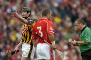 12 September 2004; Kilkenny's Martin Comerford makes a point to an umpire as Referee Aodan MacSuibhne has a word with Cork's Diarmuid O'Sullivan. Guinness All-Ireland Senior Hurling Championship Final, Cork v Kilkenny, Croke Park, Dublin. Picture credit; Brendan Moran / SPORTSFILE *** Local Caption *** Any photograph taken by SPORTSFILE during, or in connection with, the 2004 Guinness All-Ireland Hurling Final which displays GAA logos or contains an image or part of an image of any GAA intellectual property, or, which contains images of a GAA player/players in their playing uniforms, may only be used for editorial and non-advertising purposes.  Use of photographs for advertising, as posters or for purchase separately is strictly prohibited unless prior written approval has been obtained from the Gaelic Athletic Association.