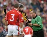 12 September 2004; Kilkenny's Martin Comerford makes his case to Referee Aodan MacSuibhne as Cork's Diarmuid O'Sullivan looks on. Guinness All-Ireland Senior Hurling Championship Final, Cork v Kilkenny, Croke Park, Dublin. Picture credit; Brendan Moran / SPORTSFILE *** Local Caption *** Any photograph taken by SPORTSFILE during, or in connection with, the 2004 Guinness All-Ireland Hurling Final which displays GAA logos or contains an image or part of an image of any GAA intellectual property, or, which contains images of a GAA player/players in their playing uniforms, may only be used for editorial and non-advertising purposes.  Use of photographs for advertising, as posters or for purchase separately is strictly prohibited unless prior written approval has been obtained from the Gaelic Athletic Association.