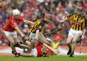 12 September 2004; Tommy Walsh and Peter Barry, right, Kilkenny, contest possession with Timmy McCarthy, left, and Niall McCarthy, Cork. Guinness All-Ireland Senior Hurling Championship Final, Cork v Kilkenny, Croke Park, Dublin. Picture credit; Brendan Moran / SPORTSFILE *** Local Caption *** Any photograph taken by SPORTSFILE during, or in connection with, the 2004 Guinness All-Ireland Hurling Final which displays GAA logos or contains an image or part of an image of any GAA intellectual property, or, which contains images of a GAA player/players in their playing uniforms, may only be used for editorial and non-advertising purposes.  Use of photographs for advertising, as posters or for purchase separately is strictly prohibited unless prior written approval has been obtained from the Gaelic Athletic Association.
