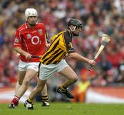 12 September 2004; Ken Coogan, Kilkenny, in action against Timmy McCarthy, Cork. Guinness All-Ireland Senior Hurling Championship Final, Cork v Kilkenny, Croke Park, Dublin. Picture credit; Brendan Moran / SPORTSFILE *** Local Caption *** Any photograph taken by SPORTSFILE during, or in connection with, the 2004 Guinness All-Ireland Hurling Final which displays GAA logos or contains an image or part of an image of any GAA intellectual property, or, which contains images of a GAA player/players in their playing uniforms, may only be used for editorial and non-advertising purposes.  Use of photographs for advertising, as posters or for purchase separately is strictly prohibited unless prior written approval has been obtained from the Gaelic Athletic Association.