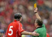 12 September 2004; John Gardiner, Cork, is shown a yellow card by referee Aodan MacSuibhne. Guinness All-Ireland Senior Hurling Championship Final, Cork v Kilkenny, Croke Park, Dublin. Picture credit; Brendan Moran / SPORTSFILE *** Local Caption *** Any photograph taken by SPORTSFILE during, or in connection with, the 2004 Guinness All-Ireland Hurling Final which displays GAA logos or contains an image or part of an image of any GAA intellectual property, or, which contains images of a GAA player/players in their playing uniforms, may only be used for editorial and non-advertising purposes.  Use of photographs for advertising, as posters or for purchase separately is strictly prohibited unless prior written approval has been obtained from the Gaelic Athletic Association.