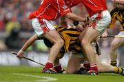 12 September 2004; Ken Coogan, Kilkenny, under pressure from Cork players. Guinness All-Ireland Senior Hurling Championship Final, Cork v Kilkenny, Croke Park, Dublin. Picture credit; Brendan Moran / SPORTSFILE *** Local Caption *** Any photograph taken by SPORTSFILE during, or in connection with, the 2004 Guinness All-Ireland Hurling Final which displays GAA logos or contains an image or part of an image of any GAA intellectual property, or, which contains images of a GAA player/players in their playing uniforms, may only be used for editorial and non-advertising purposes.  Use of photographs for advertising, as posters or for purchase separately is strictly prohibited unless prior written approval has been obtained from the Gaelic Athletic Association.