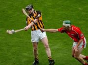 12 September 2004; Peter Barry, Kilkenny, clears under pressure from Niall McCarthy, Cork. Guinness All-Ireland Senior Hurling Championship Final, Cork v Kilkenny, Croke Park, Dublin. Picture credit; Pat Murphy / SPORTSFILE *** Local Caption *** Any photograph taken by SPORTSFILE during, or in connection with, the 2004 Guinness All-Ireland Hurling Final which displays GAA logos or contains an image or part of an image of any GAA intellectual property, or, which contains images of a GAA player/players in their playing uniforms, may only be used for editorial and non-advertising purposes.  Use of photographs for advertising, as posters or for purchase separately is strictly prohibited unless prior written approval has been obtained from the Gaelic Athletic Association.
