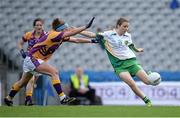 29 September 2013; Mairéad Daly, Offaly, scores her side's first goal despite the best efforts of Róisín Murphy, Wexford. TG4 All-Ireland Ladies Football Junior Championship Final, Offaly v Wexford, Croke Park, Dublin Picture credit: Brendan Moran / SPORTSFILE