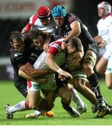 4 October 2013; Darren Cave, Ulster, is tackled by Joe Bearman, Andrew Bishop and Justin Tupuric, Ospreys. Celtic League 2013/14, Round 5, Ospreys v Ulster, Liberty Stadium, Swansea, Wales. Picture credit: Steve Pope / SPORTSFILE