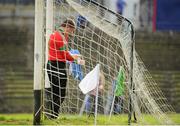 6 October 2013; St Brigid's goalkeeper Shane Curran takes his gloves off after referee Paddy Neilan blew the whistle for half time. Roscommon County Senior Club Football Championship Final, St Brigid's v Western Gaels, Dr. Hyde Park, Roscommon. Picture credit: Pat Murphy / SPORTSFILE