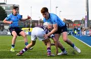 10 March 2025; Sam Dunne of St Michael's College is tackled by Ryan Mahon of Clongowes Wood College during the Bank of Ireland Leinster Rugby Boys Schools Junior Cup semi-final match between St Michael's College and Clongowes Wood College at Energia Park in Dublin. Photo by Shauna Clinton/Sportsfile