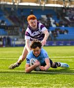 10 March 2025; Sebastian Perry of St Michael's College on his way to scoring his side's second try despite the efforts of Robert Wyse of Clongowes Wood College during the Bank of Ireland Leinster Rugby Boys Schools Junior Cup semi-final match between St Michael's College and Clongowes Wood College at Energia Park in Dublin. Photo by Shauna Clinton/Sportsfile