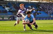 10 March 2025; Sebastian Perry of St Michael's College on his way to scoring his side's second try despite the efforts of Robert Wyse of Clongowes Wood College during the Bank of Ireland Leinster Rugby Boys Schools Junior Cup semi-final match between St Michael's College and Clongowes Wood College at Energia Park in Dublin. Photo by Shauna Clinton/Sportsfile