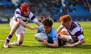 10 March 2025; Sebastian Perry of St Michael's College on his way to scoring his side's second try despite the efforts of Ryan Mahon, left, and Robert Wyse of Clongowes Wood College during the Bank of Ireland Leinster Rugby Boys Schools Junior Cup semi-final match between St Michael's College and Clongowes Wood College at Energia Park in Dublin. Photo by Shauna Clinton/Sportsfile