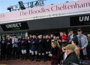 11 March 2025: Family of Michael O’Sullivan and jockeys observe a minute’s silence prior to racing on day one of the Cheltenham Racing Festival at Prestbury Park in Cheltenham, England. Photo by Harry Murphy/Sportsfile